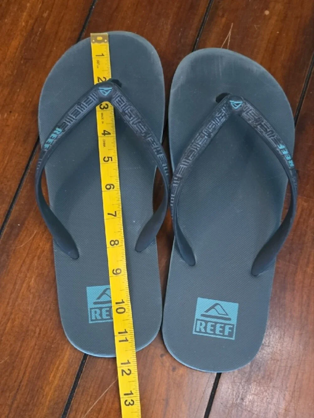 Reef Black Flip Flops with Teal Logo Accents